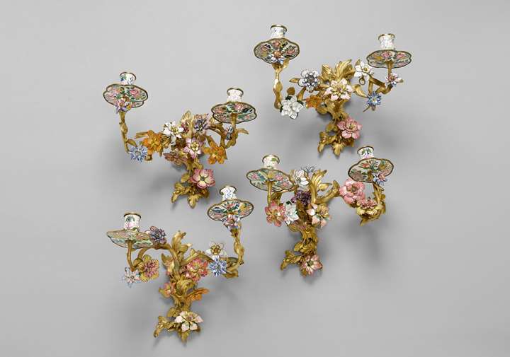 A set of four twin-branch Rococo enamel wall lights